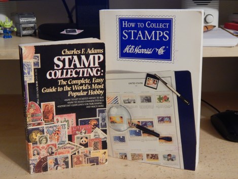 Two stamp collecting books on desk