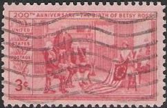 Red 3-cent U.S. postage stamp picturing Betsy Ross with American flag
