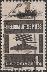 Black 4-cent U.S. postage stamp picturing hand holding quill