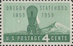 Green 4-cent U.S. postage stamp picturing covered wagon and mountain