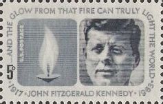 Blue gray 5-cent U.S. postage stamp picturing flame and John F. Kennedy