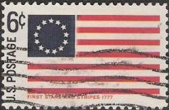 Blue and red 6-cent U.S. postage stamp picturing first 'Stars & Stripes' flag