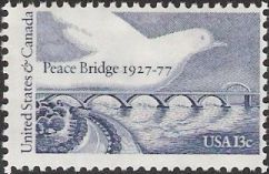 Blue 13-cent U.S. postage stamp picturing dove over Peace Bridge