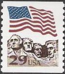 29-cent U.S. postage stamp picturing American flag over Mt. Rushmore