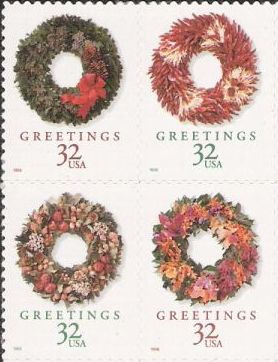 Block of four 32-cent U.S. postage stamps picturing Christmas wreaths