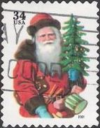34-cent U.S. postage stamp picturing Santa Claus holding tree and drum