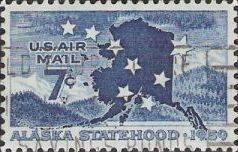 Blue 7-cent U.S. postage stamp picturing mountains and outline of Alaska