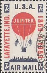 Red & blue 7-cent U.S. postage stamp picturing hot air balloon and crowd of people