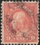 Salmon 9-cent U.S. postage stamp picturing Benjamin Franklin