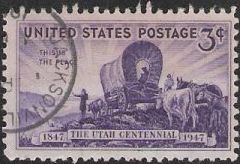 Purple 3-cent U.S. postage stamp picturing covered wagon, settlers, and livestock