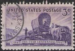 Purple 3-cent U.S. postage stamp picturing covered wagon, settlers, and livestock