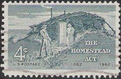 Gray blue 4-cent U.S. postage stamp picturing settlers outside cabin