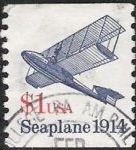 Blue & red $1 U.S. postage stamp picturing seaplane