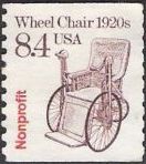 Purple & red 8.4-cent U.S. postage stamp picturing wheel chair