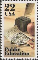 22-cent U.S. postage stamp picturing eyeglasses, paper, quill pen, and apple