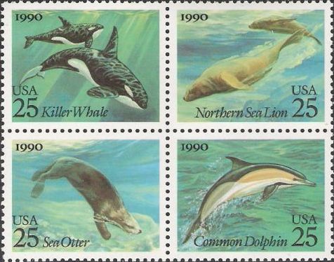 Block of four 25-cent U.S. postage stamps picturing killer whales, northern sea lion, sea otter, and common dolphin