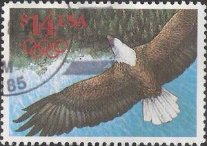 $14 U.S. postage stamp picturing bald eagle flying over coastline