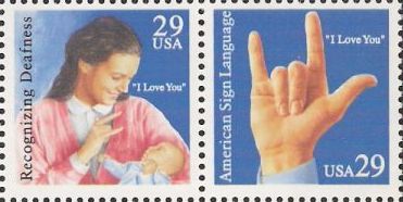 Pair of 29-cent U.S. postage stamps picturing woman and baby and hand