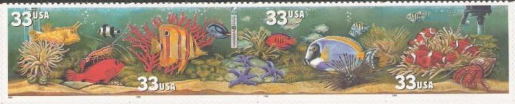 Strip of four 33-cent U.S. postage stamps picturing fish and plants in aquarium