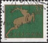 Green & gold 33-cent U.S. postage stamp picturing deer