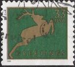 Green & gold 33-cent U.S. postage stamp picturing deer