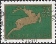 Green & gold 33-cent U.S. postage stamp picturing deer