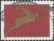 Red & gold 33-cent U.S. postage stamp picturing deer