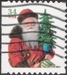 34-cent U.S. postage stamp picturing Santa Claus holding tree and drum