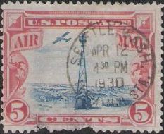 Red & blue 5-cent U.S. postage stamp picturing beacon and airplane