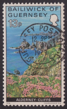 13-penny Guernsey postage stamp picturing cliffs on Alderney