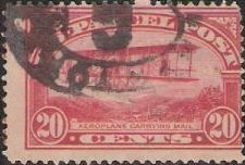 Red 20-cent U.S. postage stamp picturing biplane